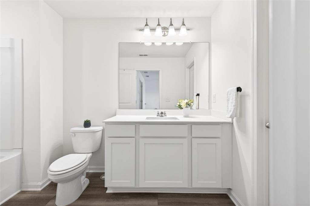 64 Thetford Way Winder, GA 30680 - Photo 18 of 41 a bathroom with a toilet sink and mirror