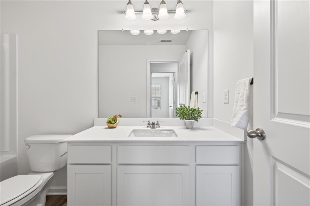 64 Thetford Way Winder, GA 30680 - Photo 25 of 41 a bathroom with a sink and a mirror
