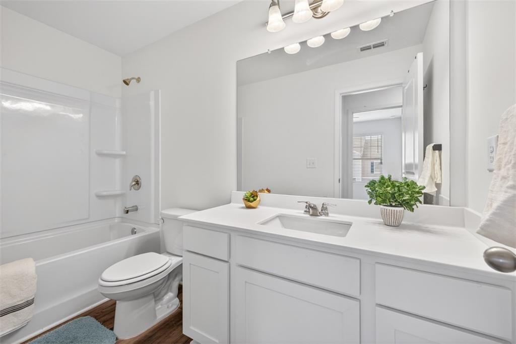 64 Thetford Way Winder, GA 30680 - Photo 26 of 41 a bathroom with a sink a toilet and shower