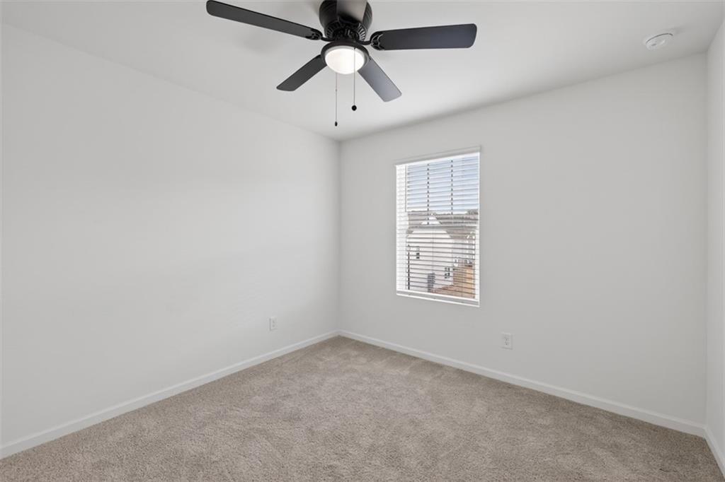 64 Thetford Way Winder, GA 30680 - Photo 27 of 41 an empty room with a window and a fan