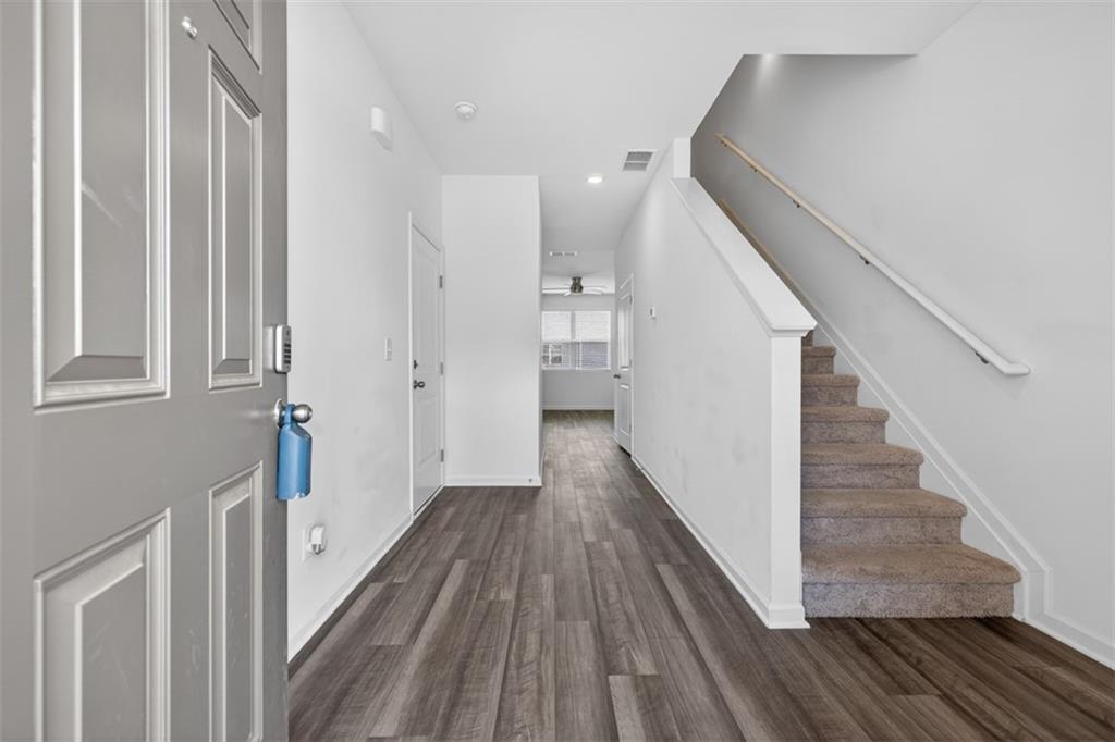 64 Thetford Way Winder, GA 30680 - Photo 4 of 41 a view of a hallway with wooden floor and staircase