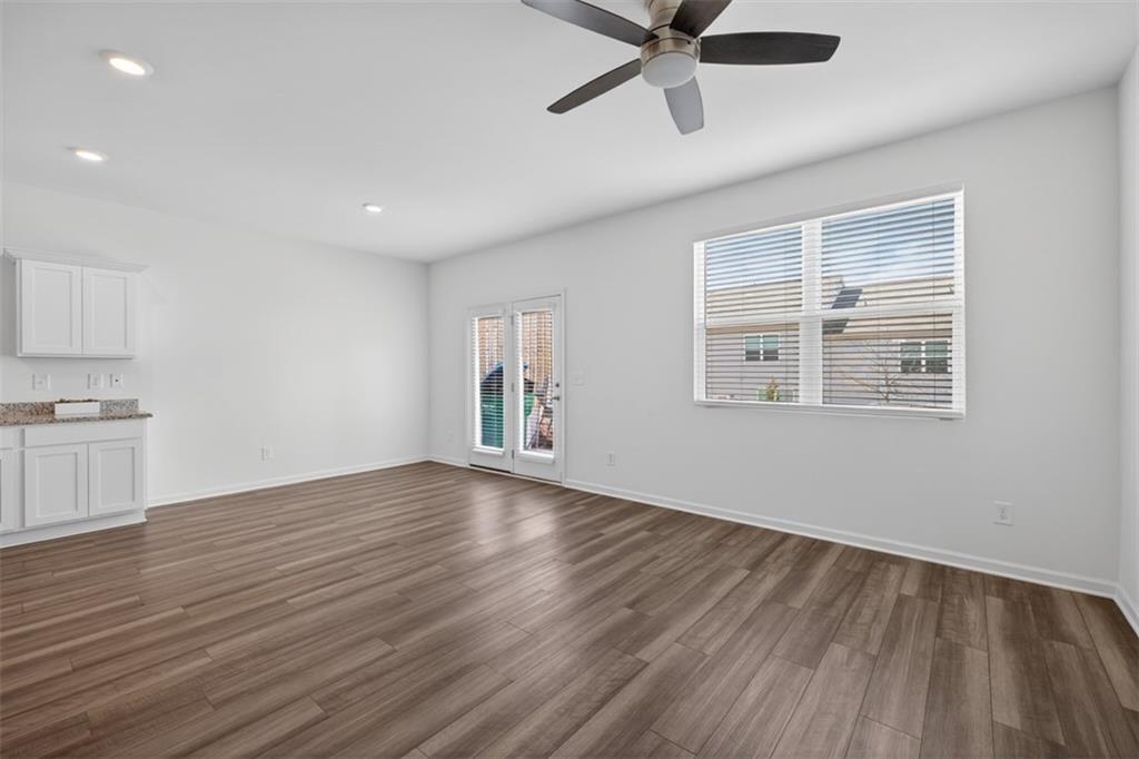 64 Thetford Way Winder, GA 30680 - Photo 5 of 41 a view of empty room with wooden floor and fan