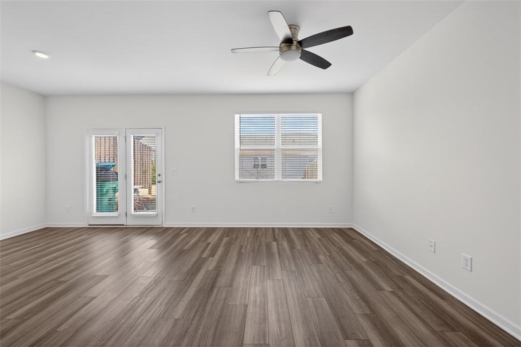 64 Thetford Way Winder, GA 30680 - Photo 6 of 41 a view of empty room with wooden floor and fan