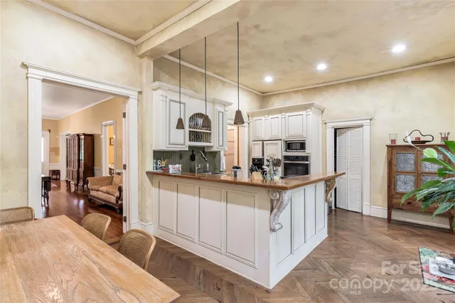 a kitchen with stainless steel appliances a sink and a refrigerator