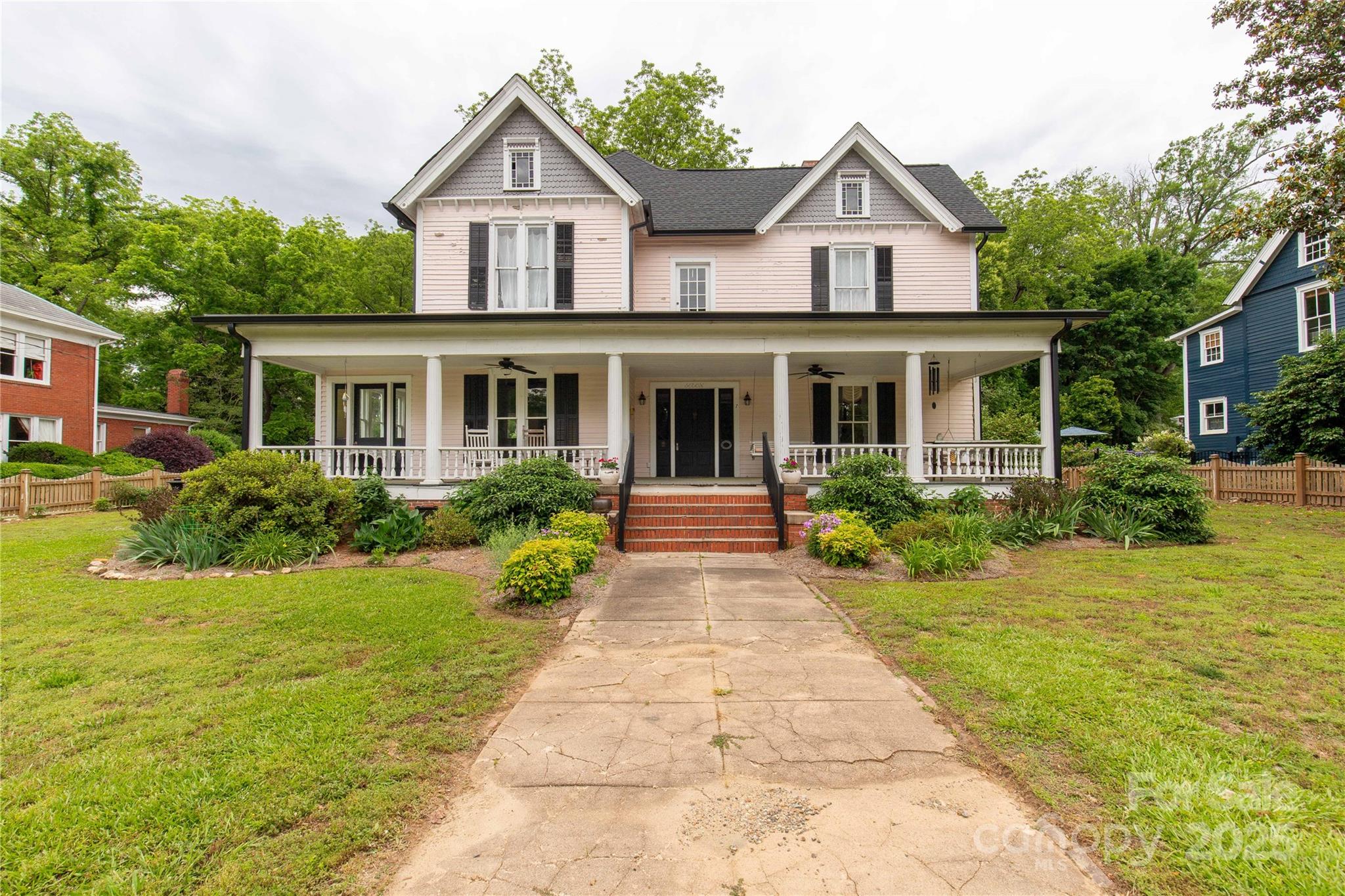 7 Kings Mountain Street York, SC 29745 - Photo 2 of 46 a front view of a house with a yard and potted plants