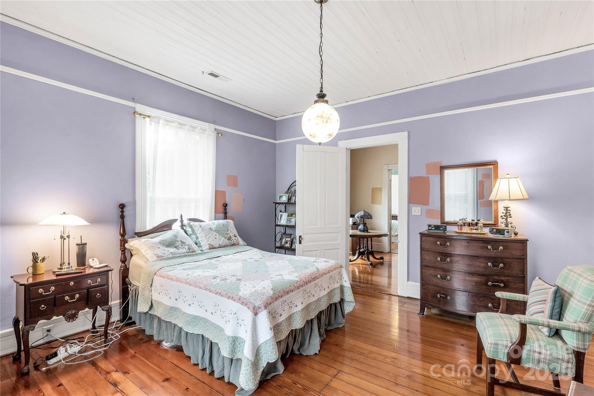 7 Kings Mountain Street York, SC 29745 - Photo 23 of 46 a spacious bedroom with a bed and a chandelier