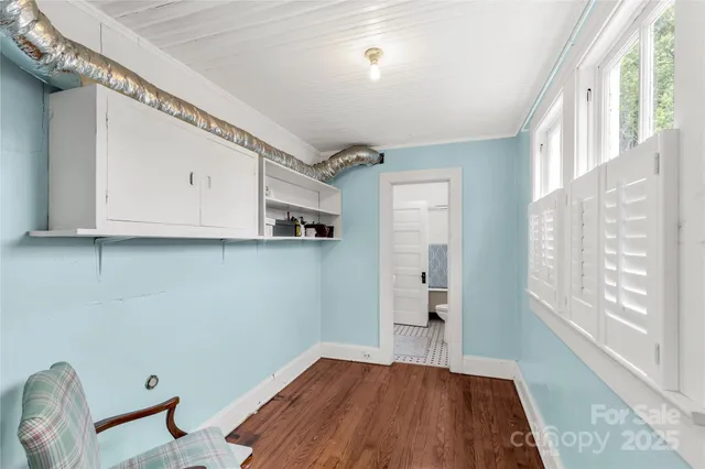 a view of a livingroom with wooden floor and a window