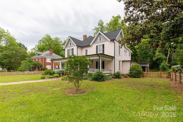 a front view of a house with a yard table and chairs