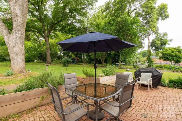 a patio with a yard table and chairs