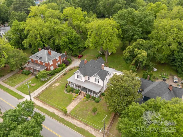 an aerial view of a residential houses with outdoor space