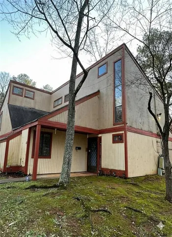 a house that has a tree in front of it