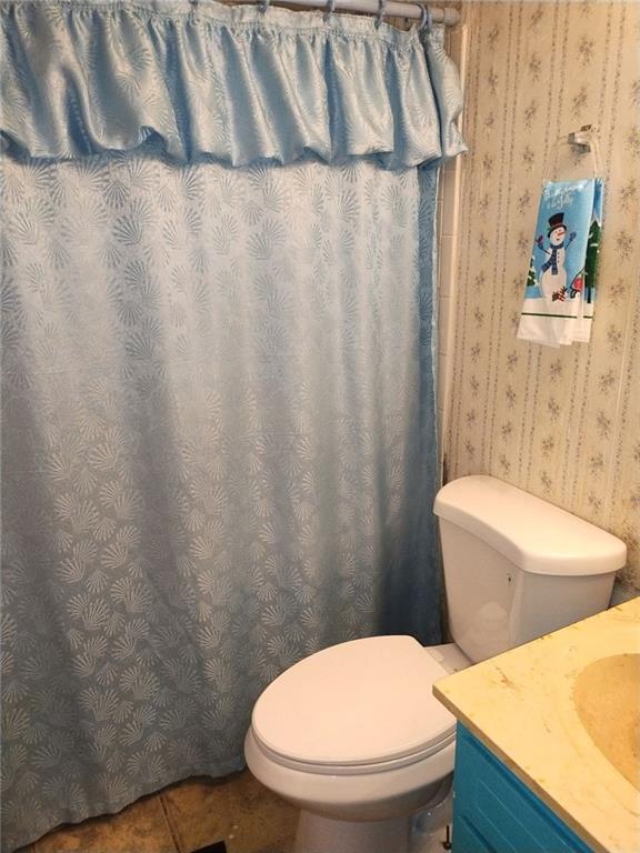 3398 Columbia Trace Decatur, GA 30032 - Photo 9 of 10 a white toilet sitting next to a shower curtain