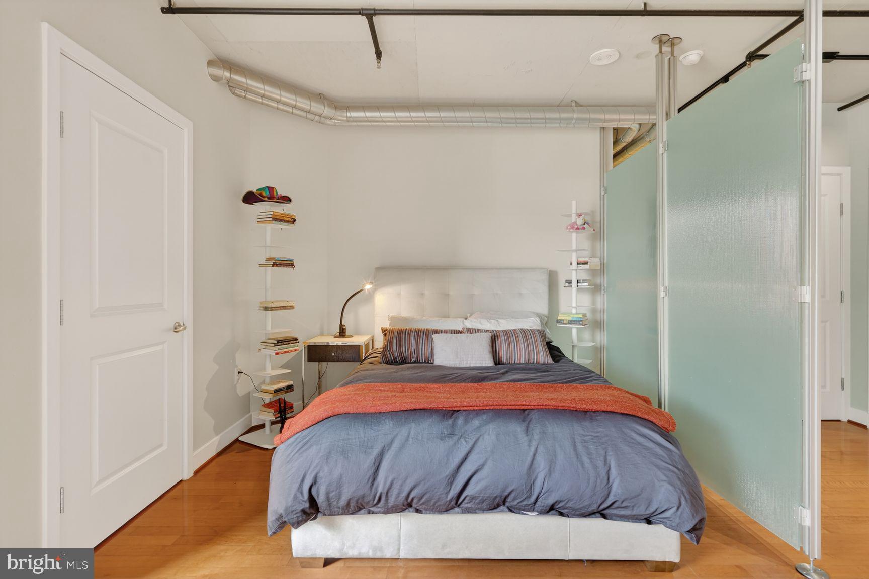2125 14th Street Northwest, Unit 531 Washington, DC 20009 - Photo 11 of 20 a bedroom with a bed and a mirror