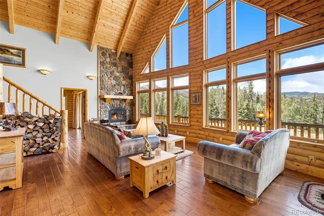 a view of a dining room with furniture a chandelier and wooden floor