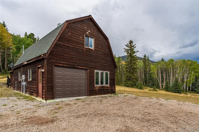 a living room with furniture and floor to ceiling windows
