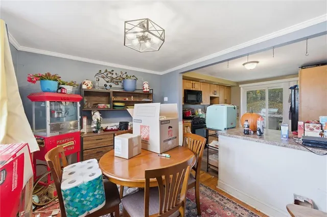 a view of a dining room with furniture and a chandelier