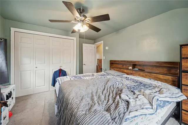 a bedroom with a large bed and a chandelier