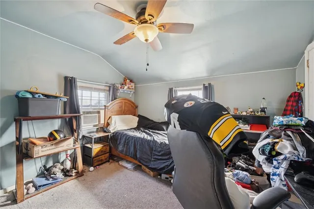 a bedroom with two beds and a chandelier