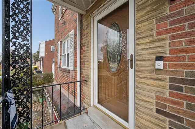 a view of a balcony with wooden floor and glass door