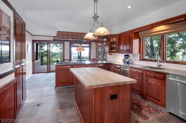 a kitchen with stainless steel appliances granite countertop sink stove and refrigerator