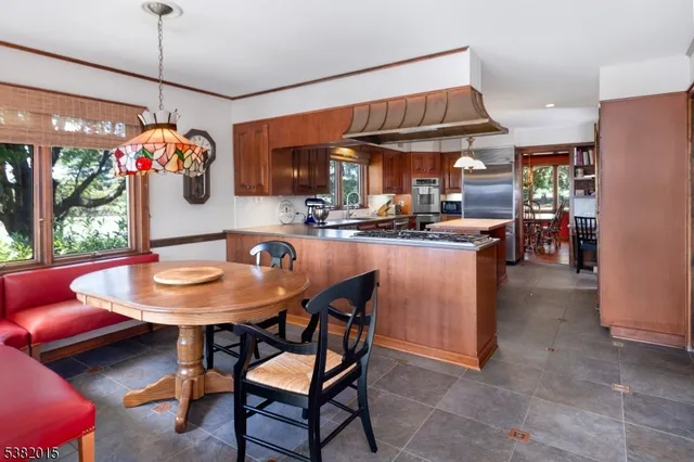 a dining room filled with lots of furniture and a chandelier