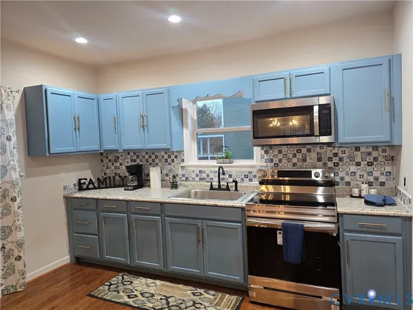 a kitchen with a sink stove and microwave
