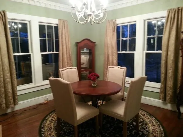a dining room with furniture a rug and wooden floor