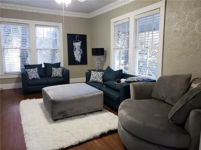 a living room with furniture and large windows