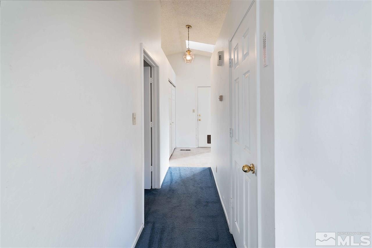 6314 Moon Ridge Terrace Reno, NV 89523 - Photo 11 of 24 a view of a hallway with wooden floor