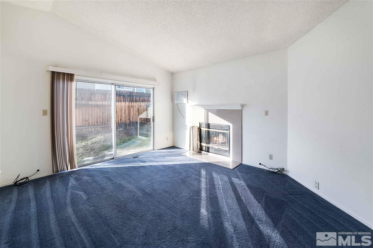 6314 Moon Ridge Terrace Reno, NV 89523 - Photo 7 of 24 a view of empty room with wooden floor and fireplace