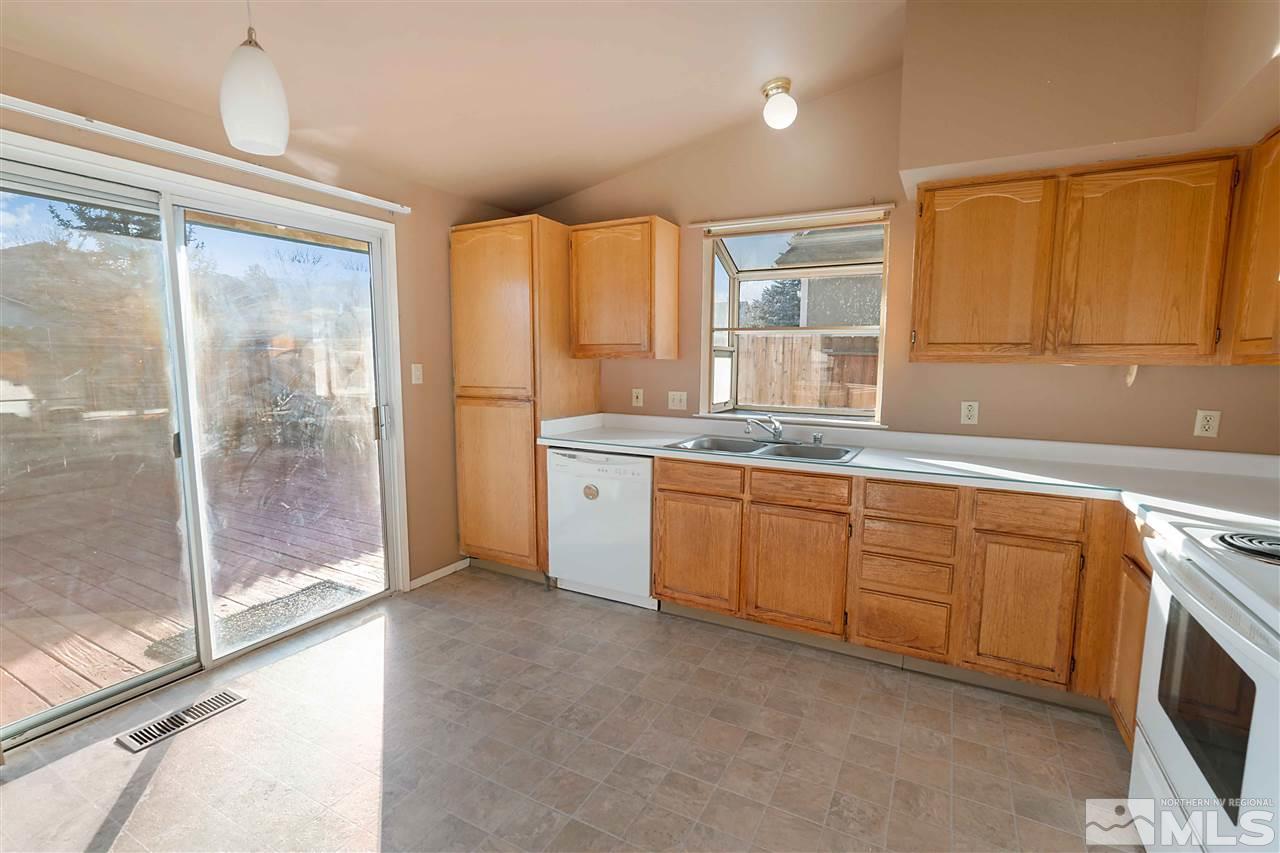6314 Moon Ridge Terrace Reno, NV 89523 - Photo 8 of 24 a kitchen with granite countertop a sink and a refrigerator