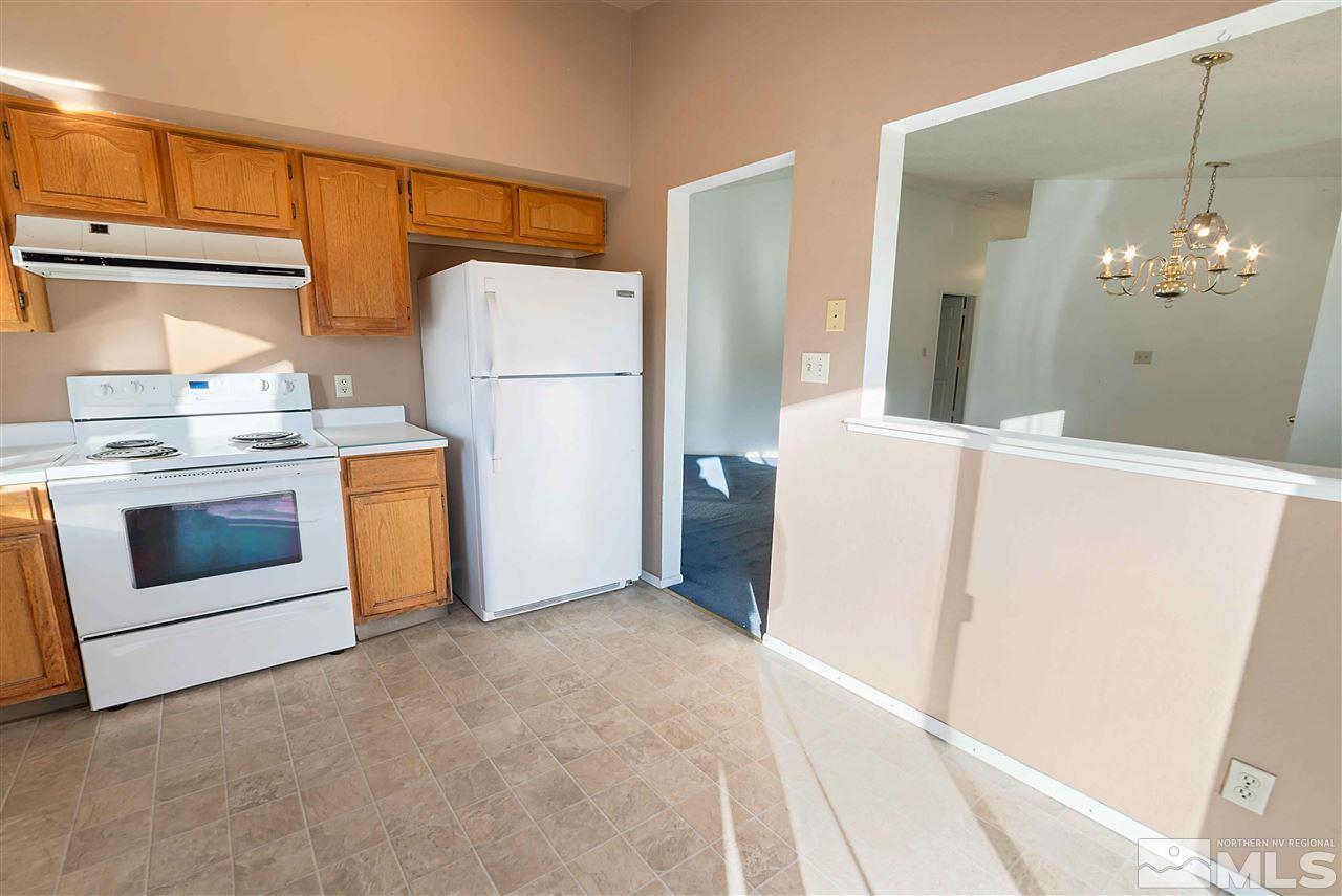 6314 Moon Ridge Terrace Reno, NV 89523 - Photo 9 of 24 a kitchen with white cabinets and white appliances