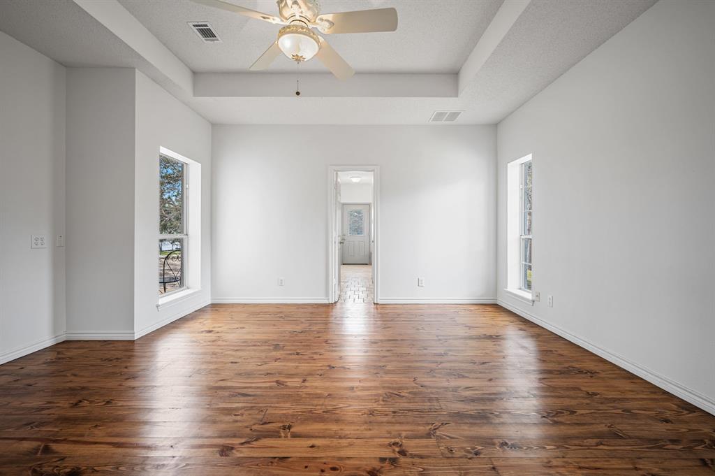 5327 Dusty Road Athens, TX 75752 - Photo 19 of 35 a view of an empty room with wooden floor and a window