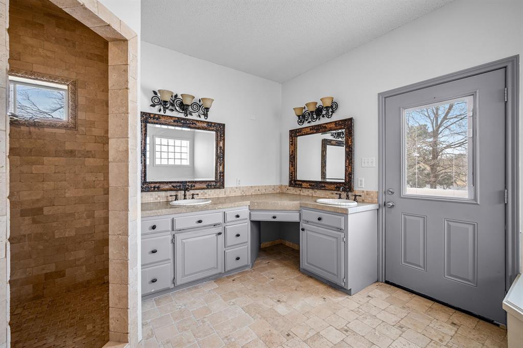 5327 Dusty Road Athens, TX 75752 - Photo 20 of 35 a spacious bathroom with a granite countertop double vanity sink a mirror and a bathtub