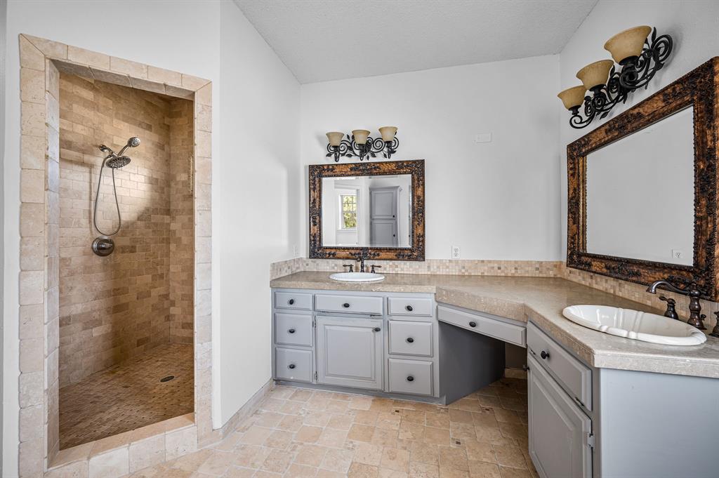 5327 Dusty Road Athens, TX 75752 - Photo 21 of 35 a bathroom with a granite countertop sink a mirror and a shower