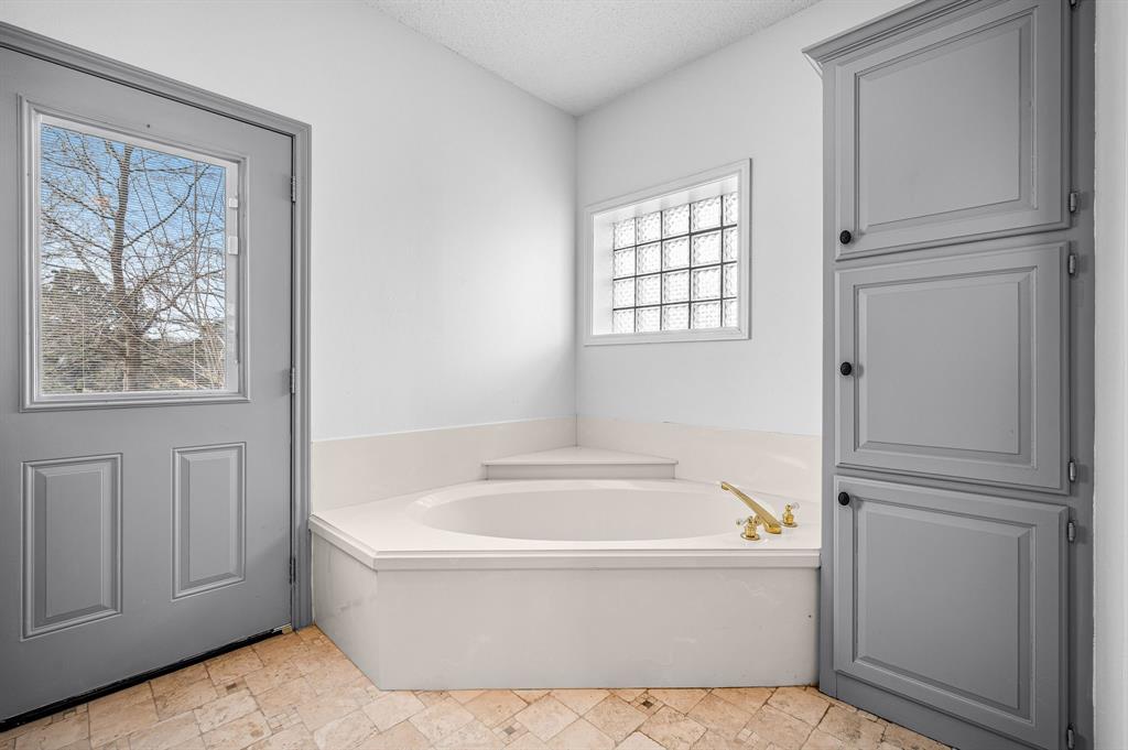 5327 Dusty Road Athens, TX 75752 - Photo 22 of 35 a white bath tub sitting in a bathroom next to a window