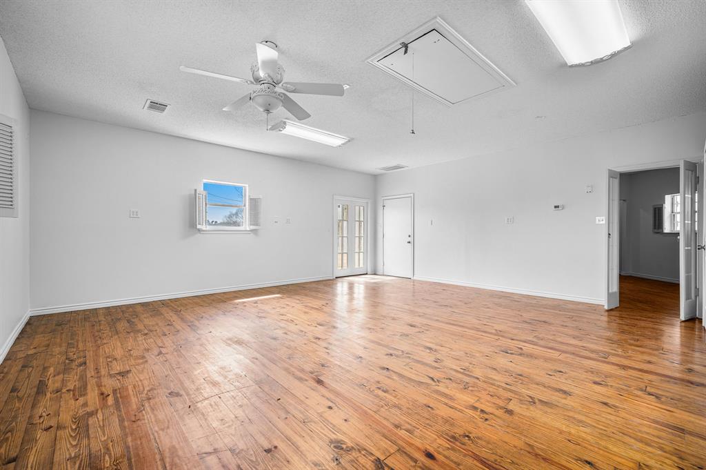 5327 Dusty Road Athens, TX 75752 - Photo 27 of 35 a view of an empty room with wooden floor and a ceiling fan
