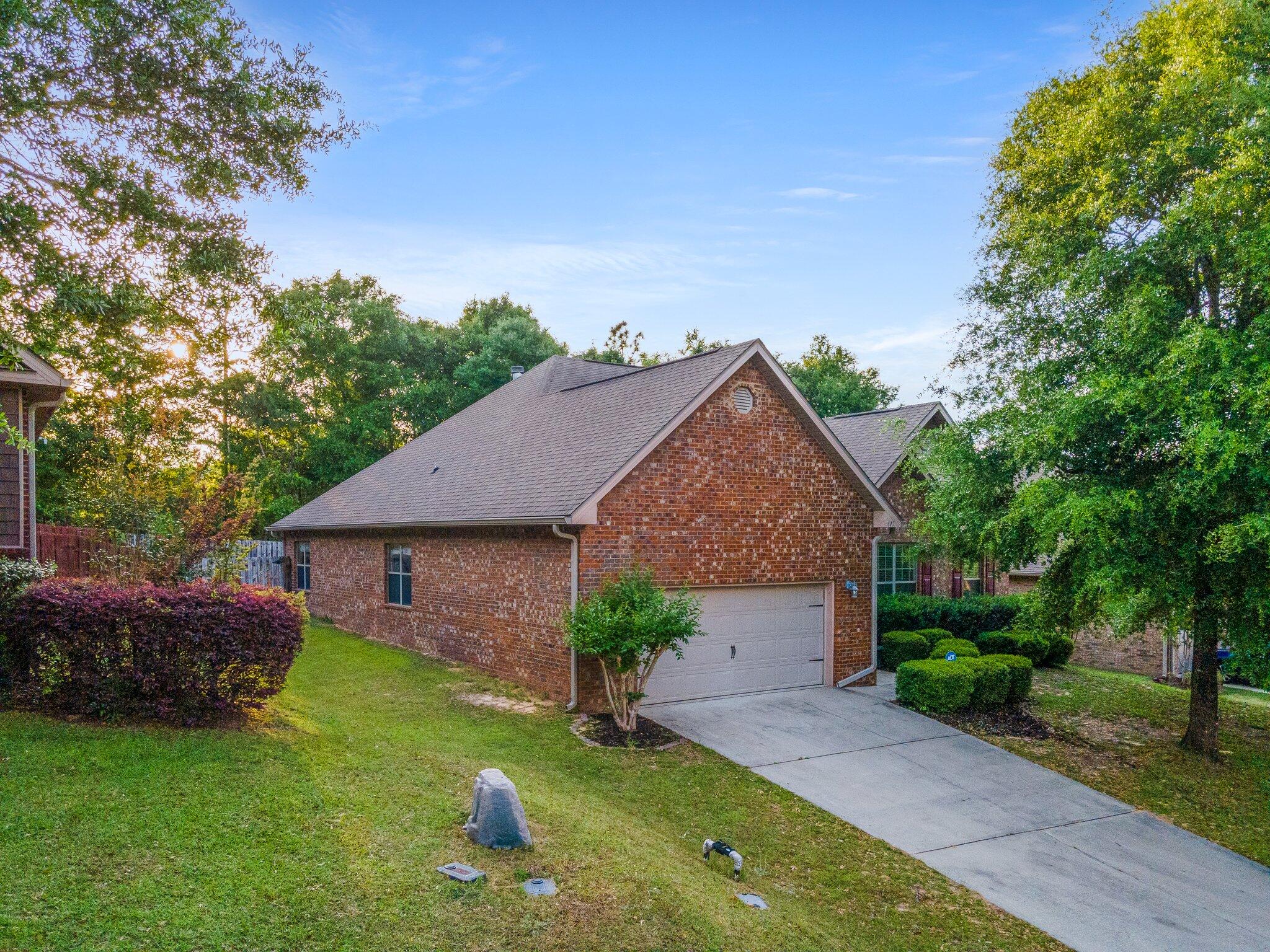 613 Red Fern Road Crestview, FL 32536 - Photo 1 of 39 a front view of a house with garden
