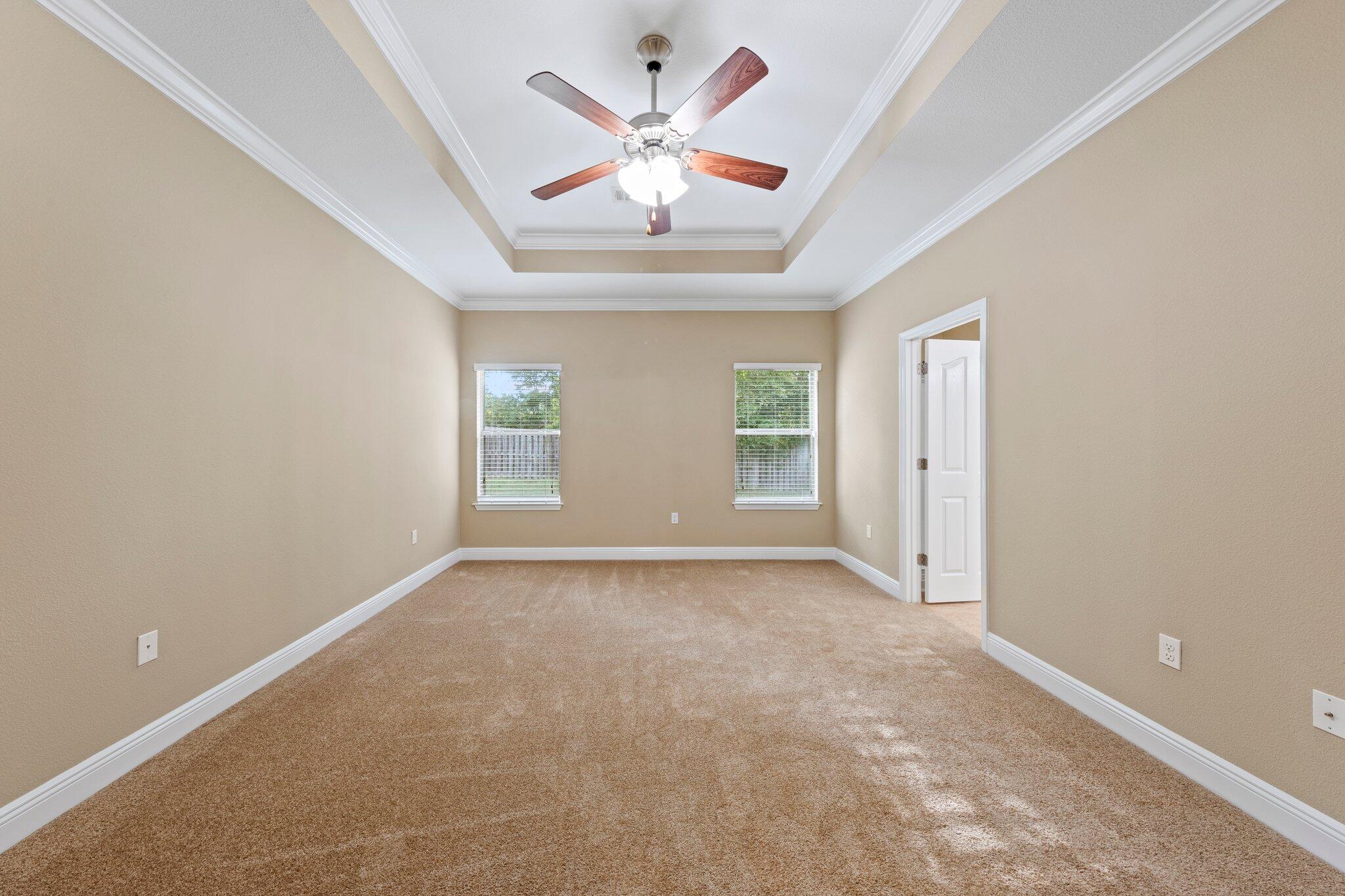 613 Red Fern Road Crestview, FL 32536 - Photo 14 of 39 an empty room with chandelier fan and windows