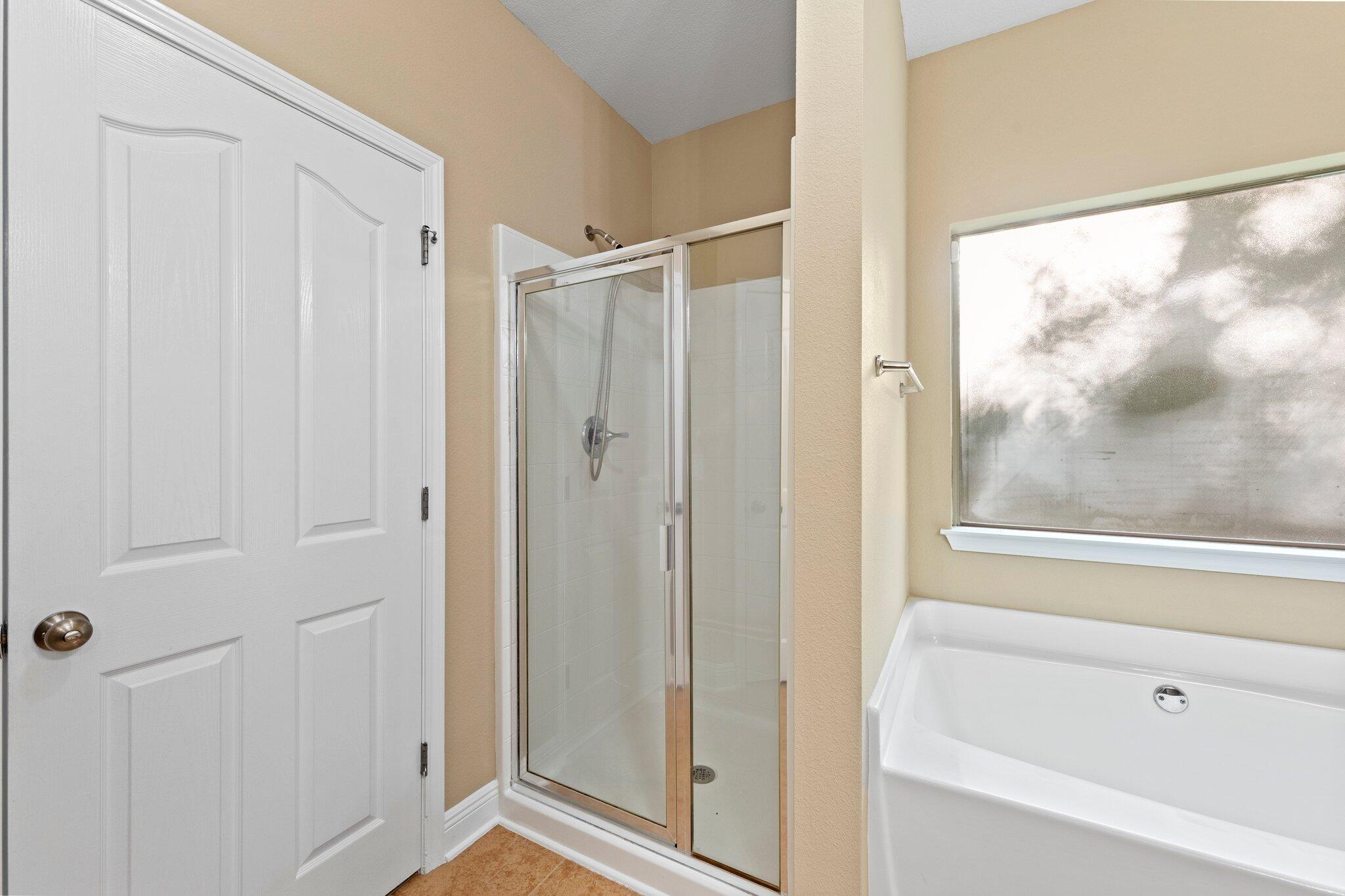 613 Red Fern Road Crestview, FL 32536 - Photo 16 of 39 a bathroom with a glass shower door