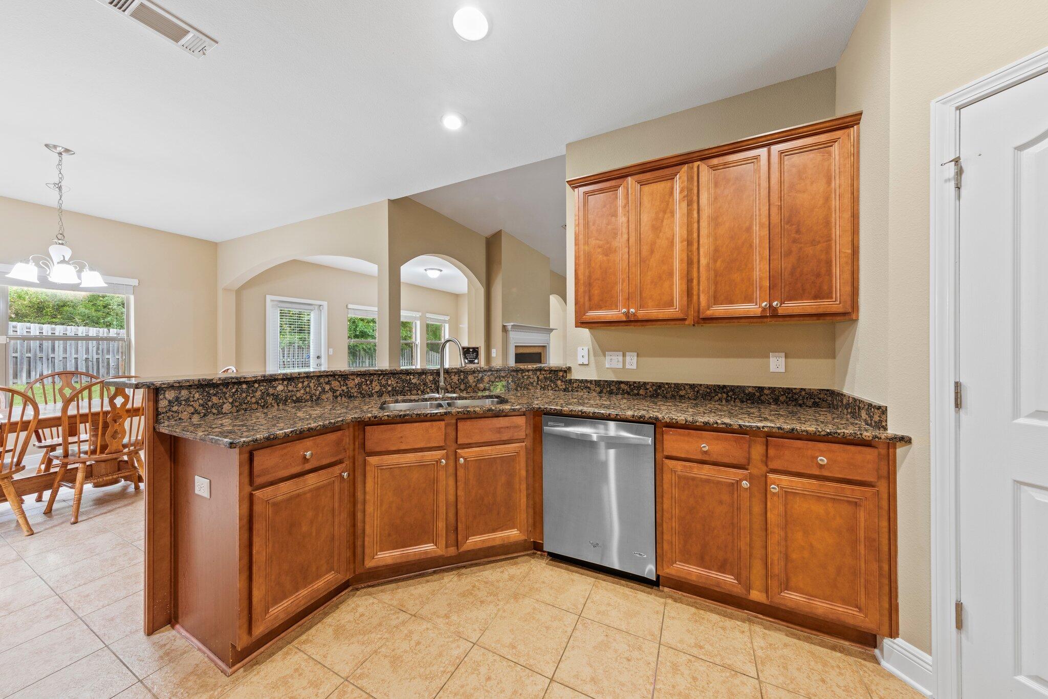 613 Red Fern Road Crestview, FL 32536 - Photo 28 of 39 a kitchen with granite countertop sink stove and cabinets