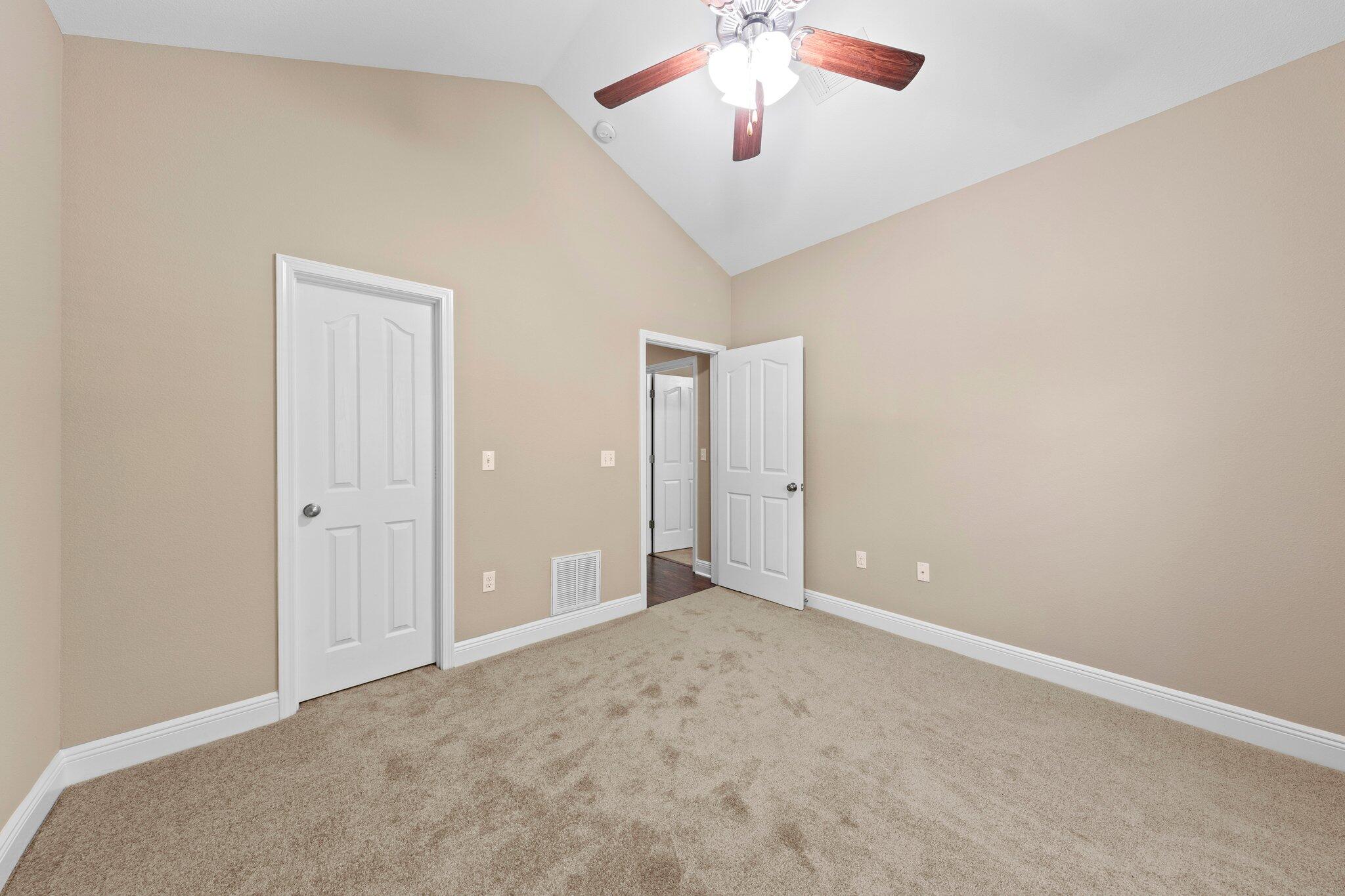 613 Red Fern Road Crestview, FL 32536 - Photo 5 of 39 an empty room with a empty space and a ceiling fan