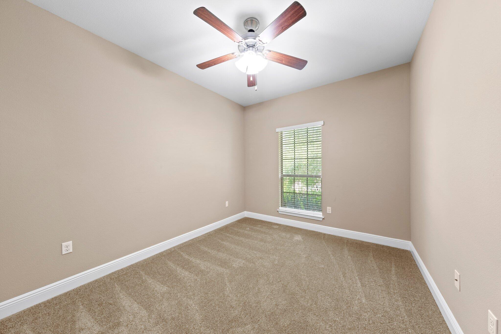 613 Red Fern Road Crestview, FL 32536 - Photo 6 of 39 an empty room with windows and fan