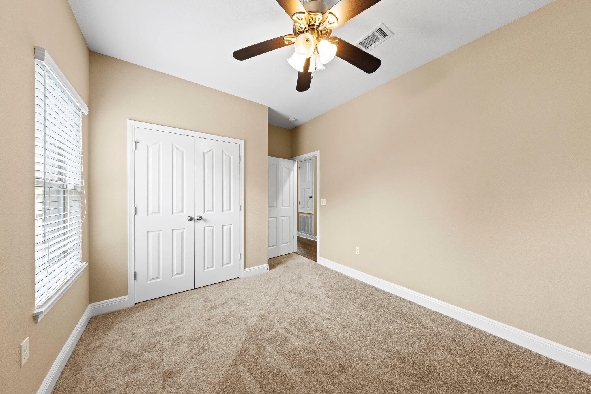 613 Red Fern Road Crestview, FL 32536 - Photo 9 of 39 an empty room with fan and windows