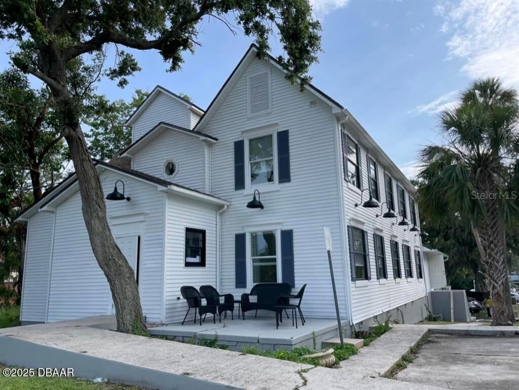404 South Ridgewood Avenue Daytona Beach, FL 32114 - Photo 20 of 53 a front view of a house with outdoor seating