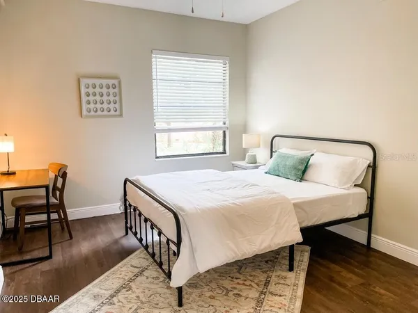 a bedroom with a bed and a table