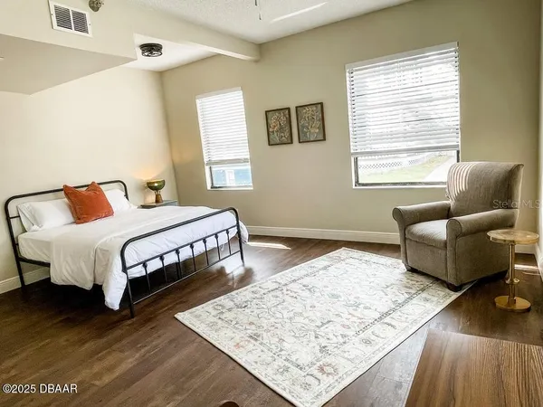 a bed sitting in a bedroom next to a window