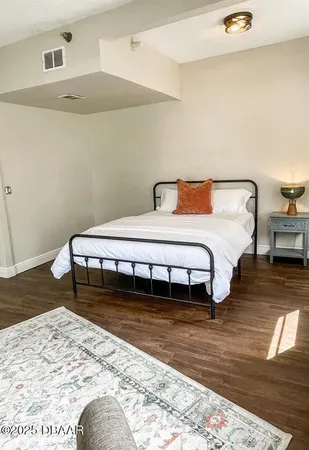 a view of a room with wooden floor and furniture