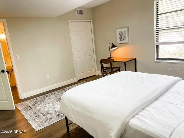 a white toilet sitting next to a shower