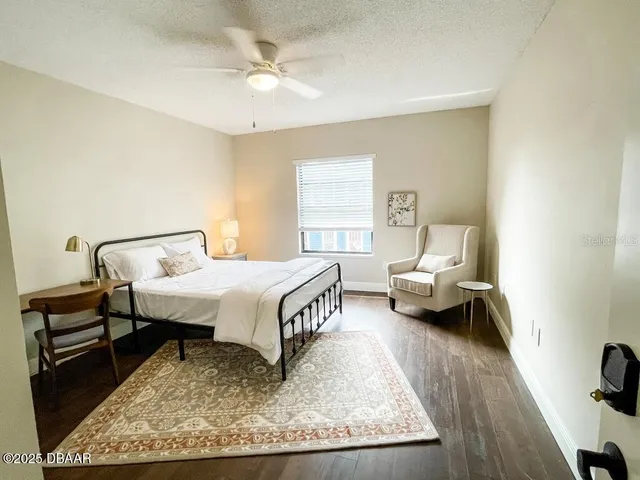 a bedroom with a bed and chair